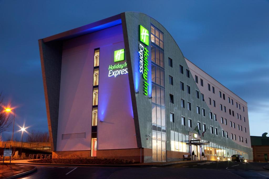 a building with a sign on the side of it at Holiday Inn Express Tamworth, an IHG Hotel in Tamworth