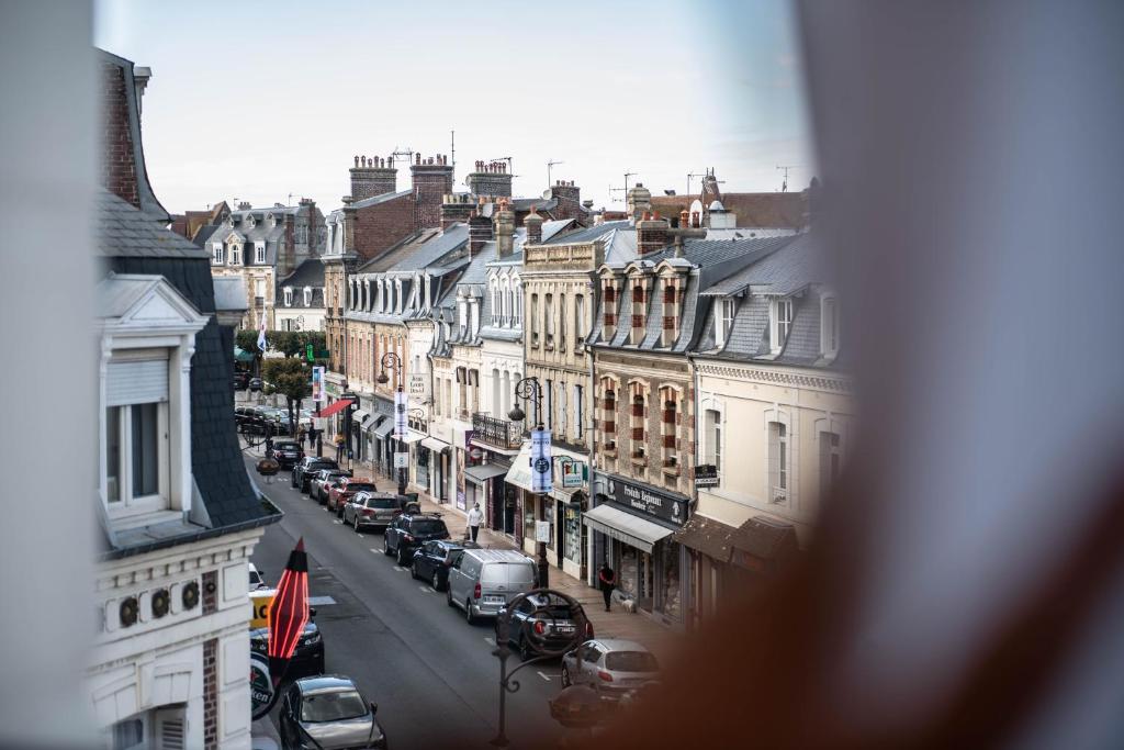 a view of a city street with cars parked at YOU Are Deauville in Deauville