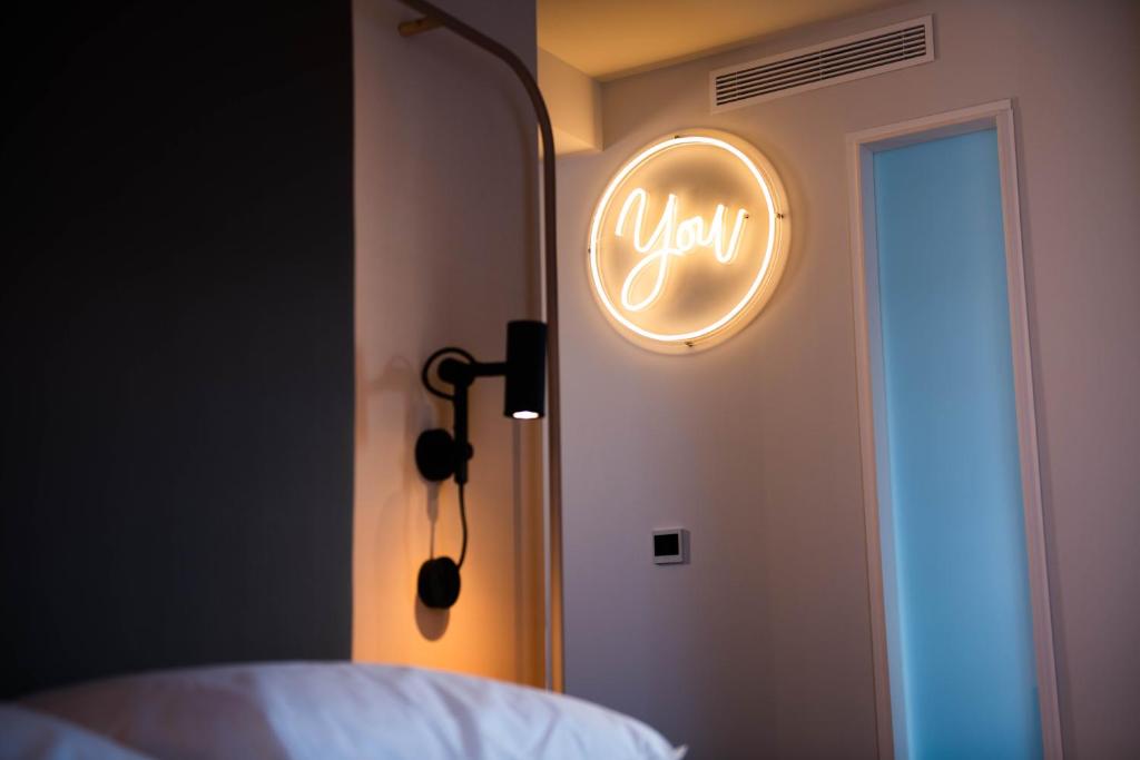 a neon sign that says your on a bedroom door at YOU Are Deauville in Deauville