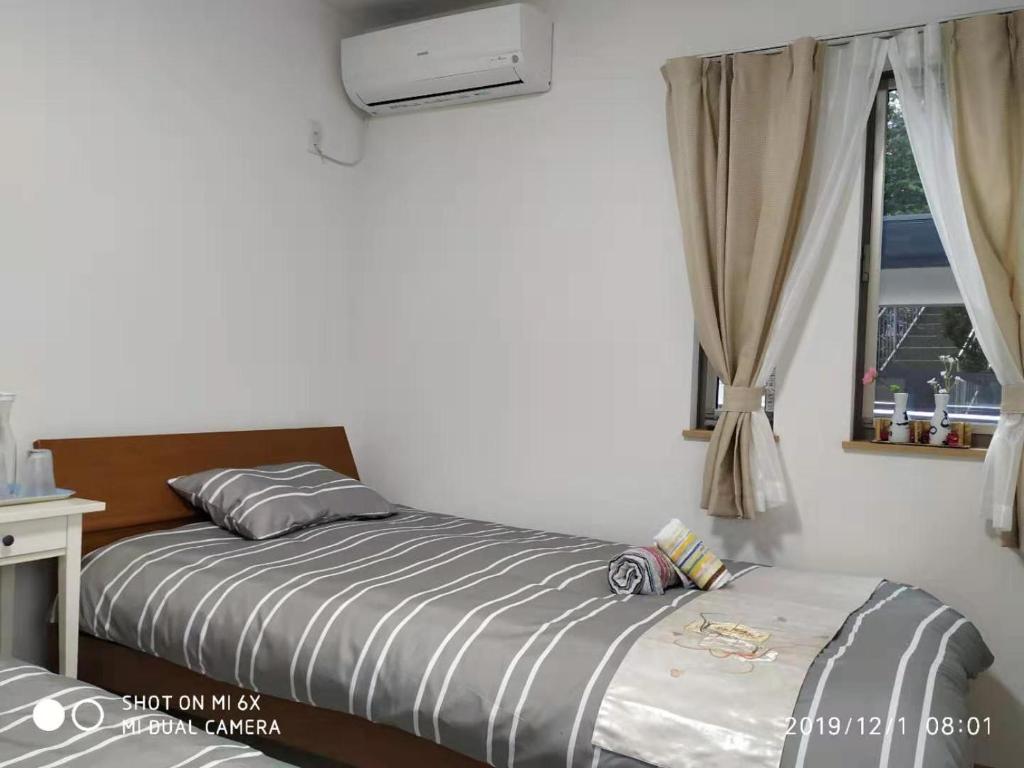 Postel nebo postele na pokoji v ubytování guest house 鎌倉記憶