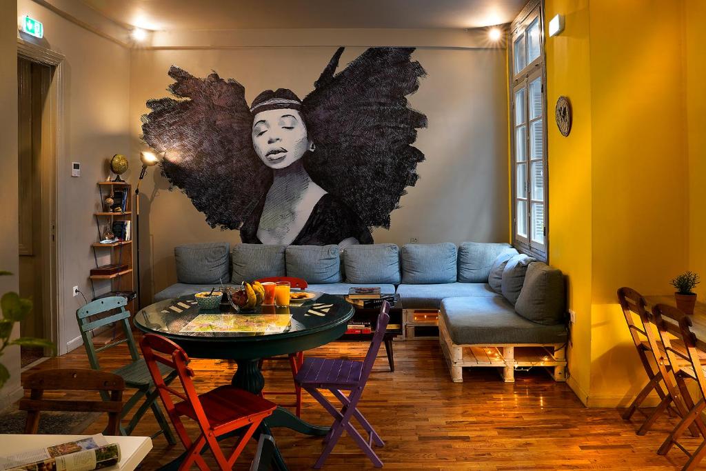 a living room with a blue couch and a table at Nubian Hostel in Athens