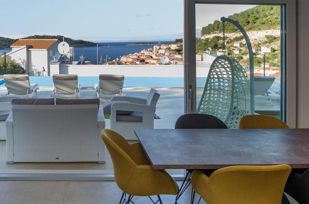 a table and chairs with a view of the ocean at Luxury Blue Villas Vis in Vis