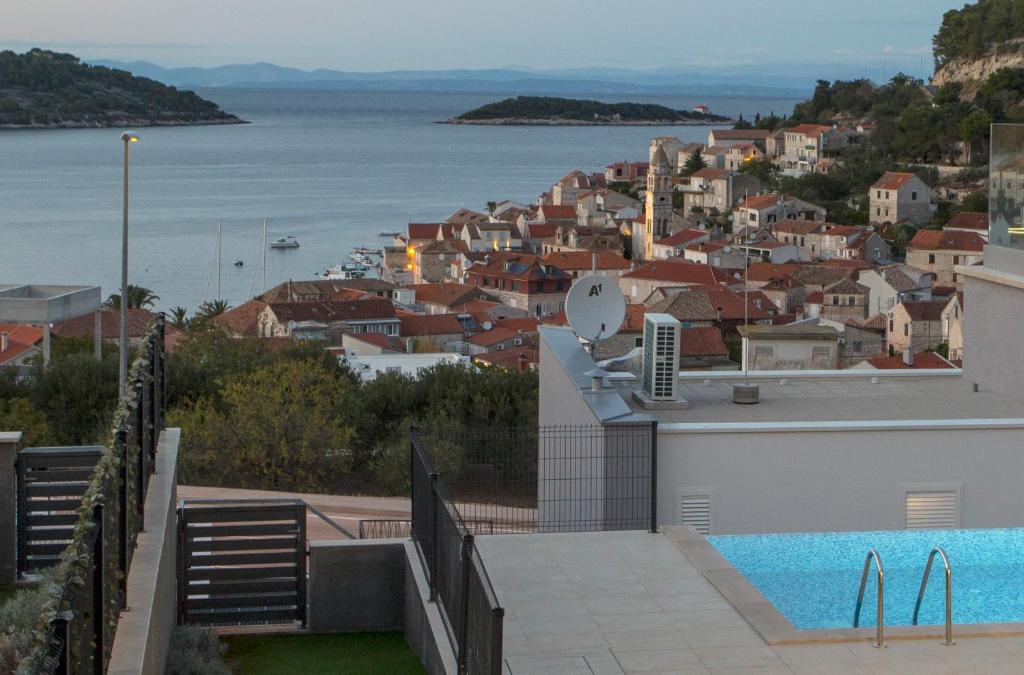 a villa with a swimming pool and a city at Luxury Blue Villas Vis in Vis