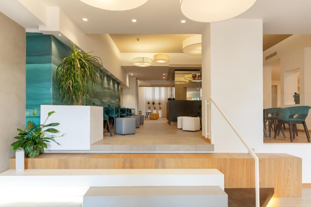 a living room with a staircase and a lobby at Albatros Beach Hotel in Letojanni