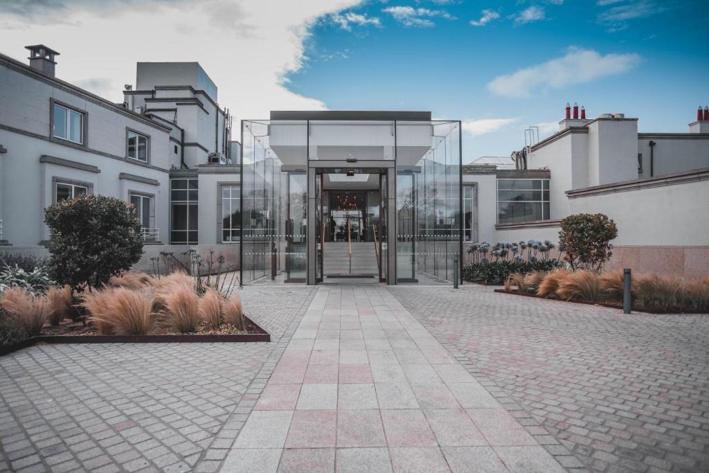 a building with a glass door in a courtyard at Portmarnock Resort & Jameson Golf Links in Portmarnock