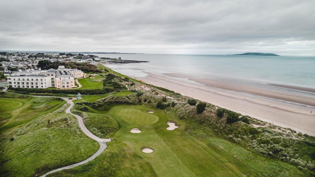 an aerial view of a golf course next to the beach at Portmarnock Resort & Jameson Golf Links in Portmarnock