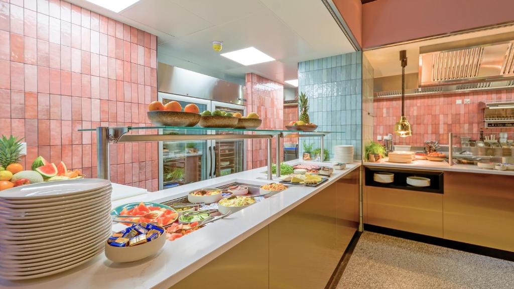 a large kitchen with plates of food on a counter at Hotel Sonne in Füssen