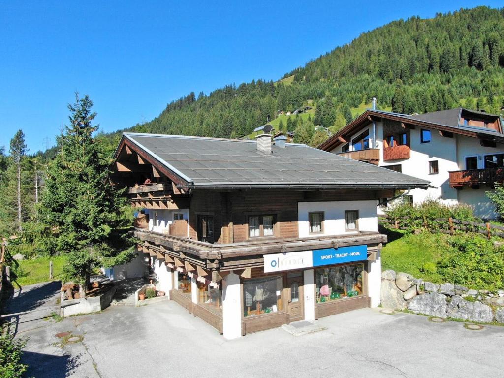 a large wooden building in the middle of a mountain at Ferienwohnung Königsleiten 3 Top 5 in Wald im Pinzgau