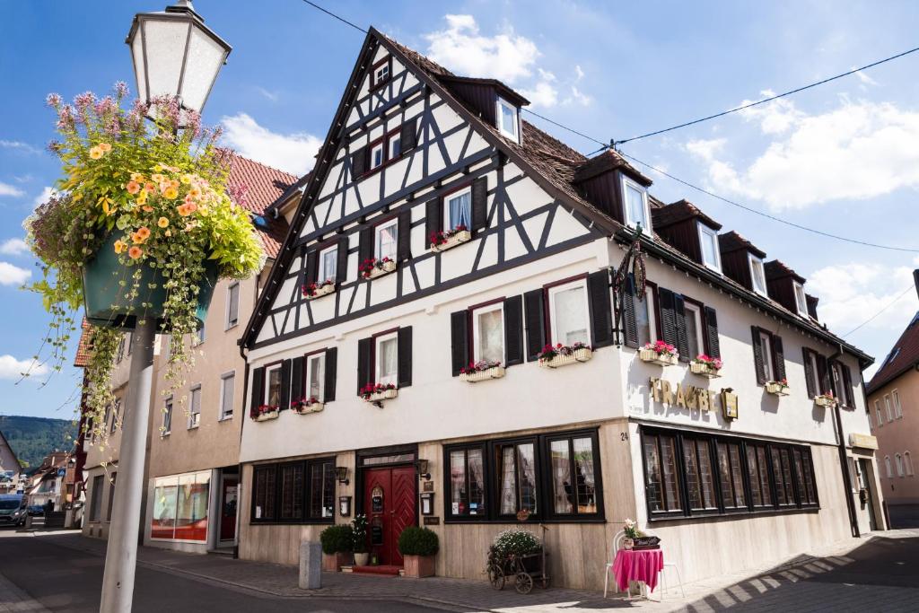 a white and black building on a city street at Hotel - Restaurant Traube in Neuffen