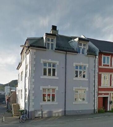 a white building on the side of a street at Homestay in Prestenggata in Tromsø