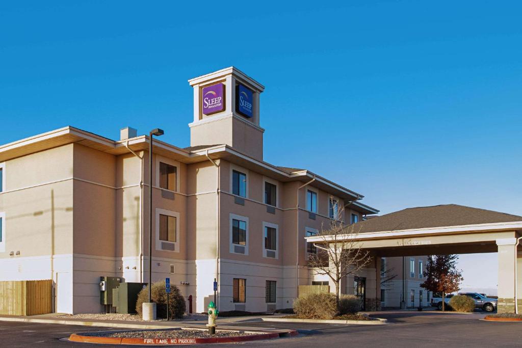 a building with a clock tower on top of it at Sleep Inn & Suites in Hobbs