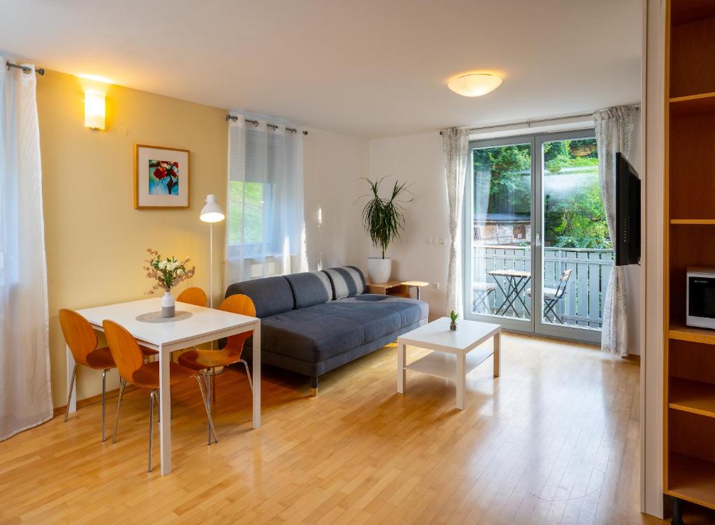 a living room with a couch and a table at Apartment Muznik in Bled