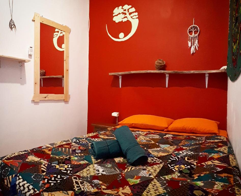 a bedroom with a bed with a colorful quilt on it at L'isola che... in Karimunjawa