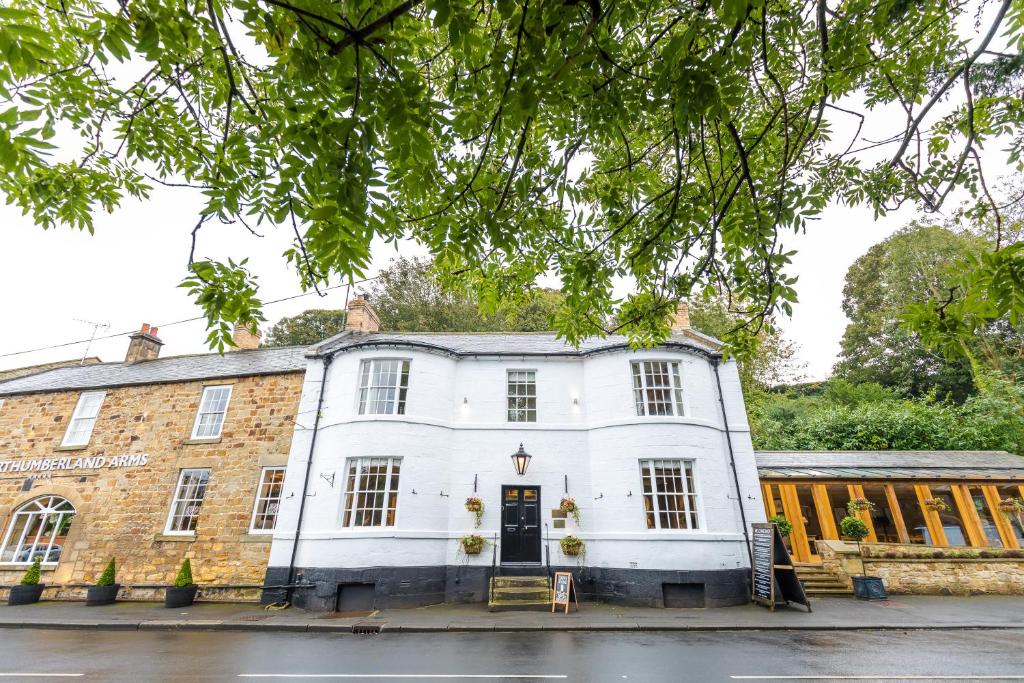 an image of a white building with a tree at The Northumberland Arms in West Thirston