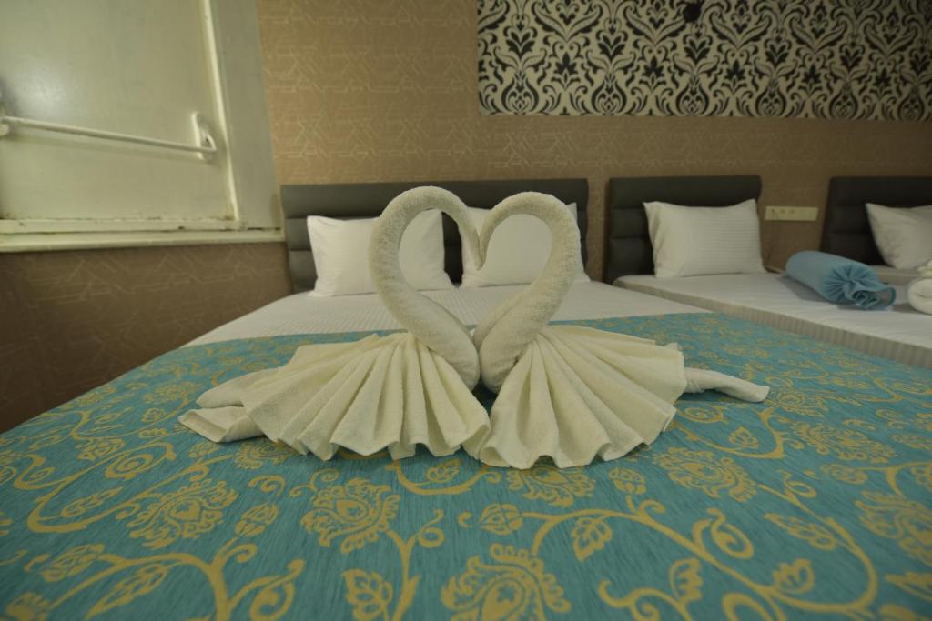 A bed or beds in a room at Omega Luxx Hotel