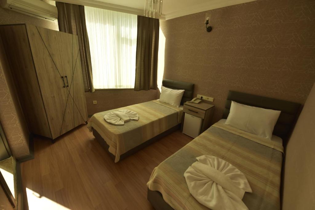 A bed or beds in a room at Omega Luxx Hotel