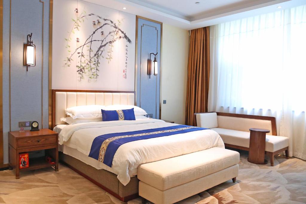 Postel nebo postele na pokoji v ubytování Guangdong Yingbin Hotel-Free Canton Fair Shuttle Bus