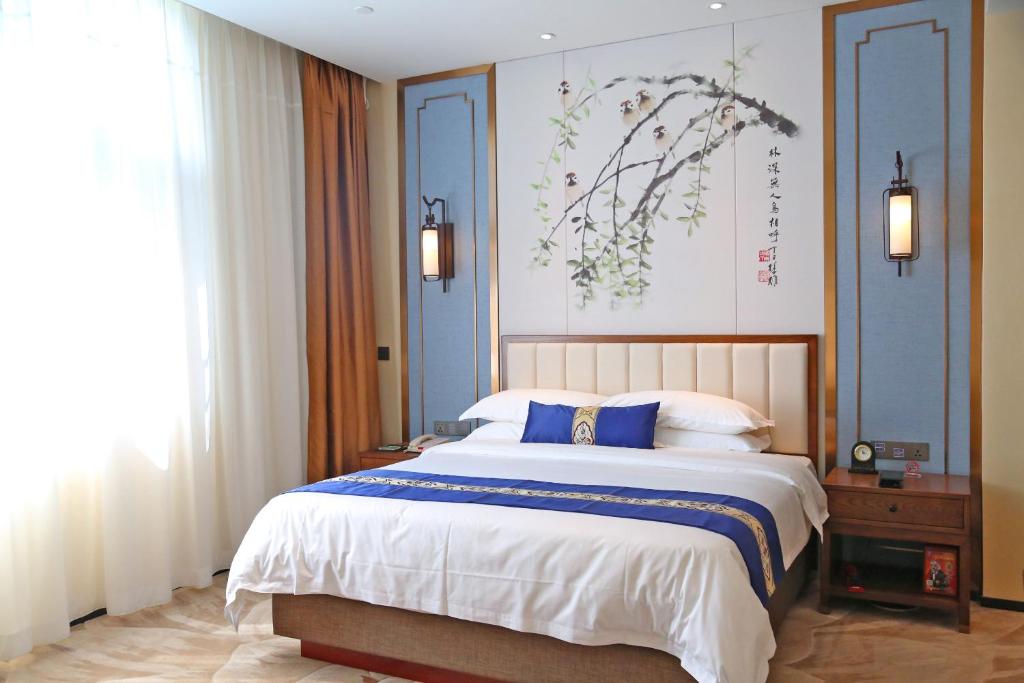 Postel nebo postele na pokoji v ubytování Guangdong Yingbin Hotel-Free Canton Fair Shuttle Bus