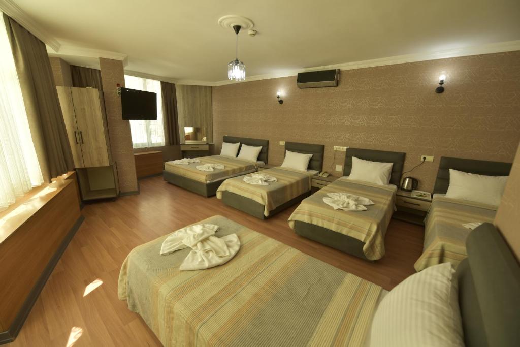 A bed or beds in a room at Omega Luxx Hotel