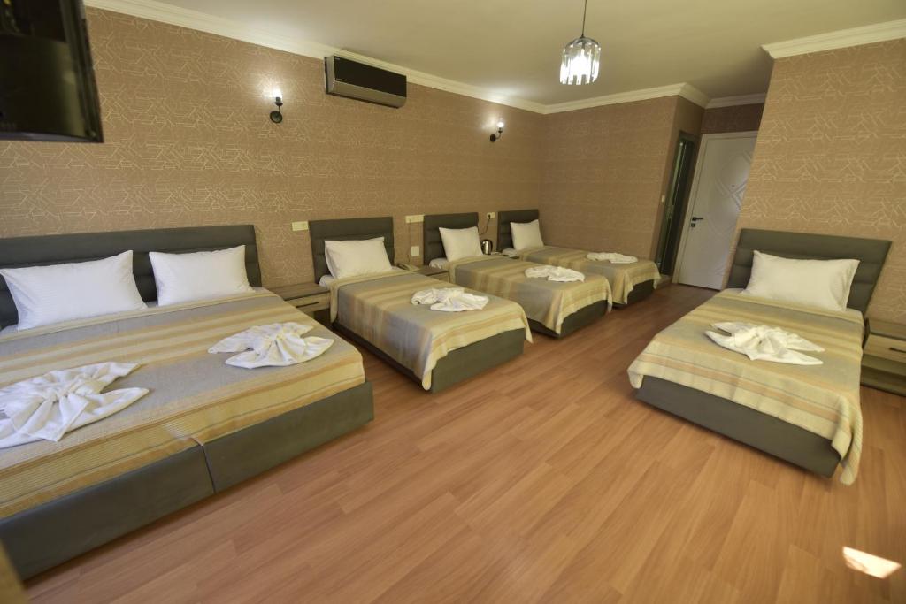 A bed or beds in a room at Omega Luxx Hotel