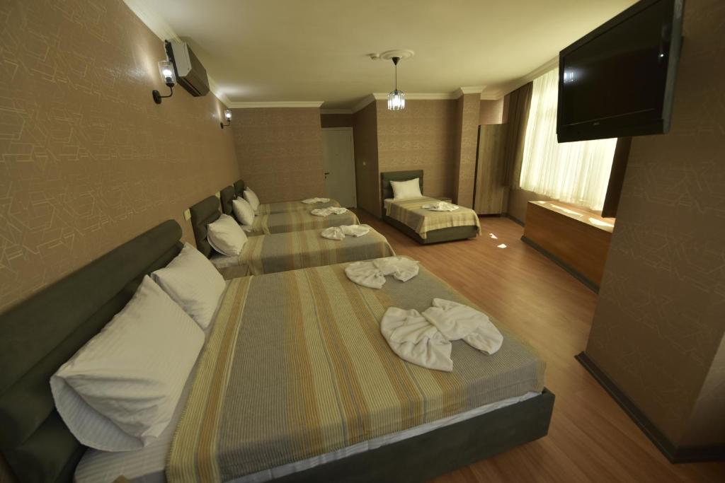 A bed or beds in a room at Omega Luxx Hotel