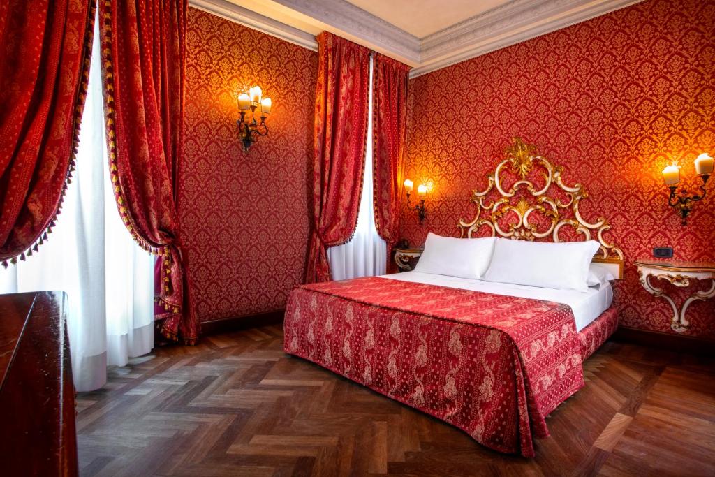 Łóżko lub łóżka w pokoju w obiekcie Palazzina Veneziana