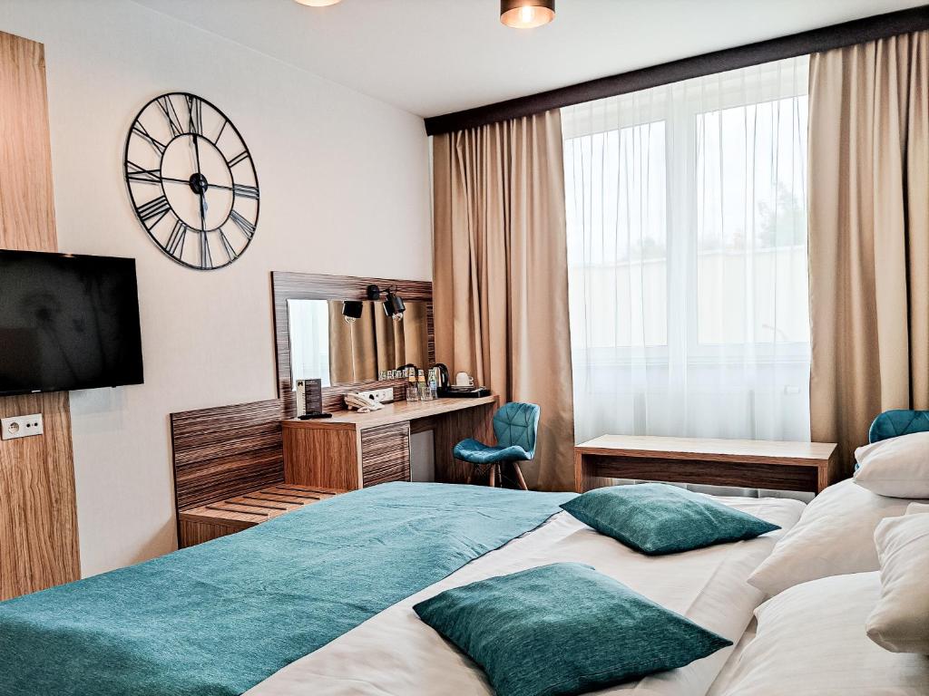Postel nebo postele na pokoji v ubytování Hotel Milenium