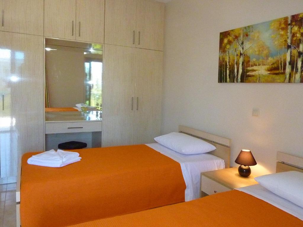 A bed or beds in a room at Villa Vassilis Fiscardo Kefalonia
