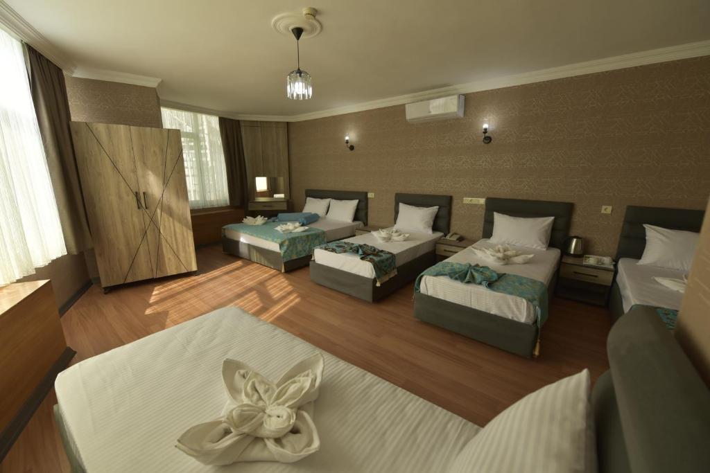 A bed or beds in a room at Omega Luxx Hotel