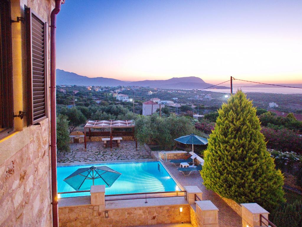 a villa with a swimming pool and a view at Villa Afrati Sea Views Pool AC in Plaka