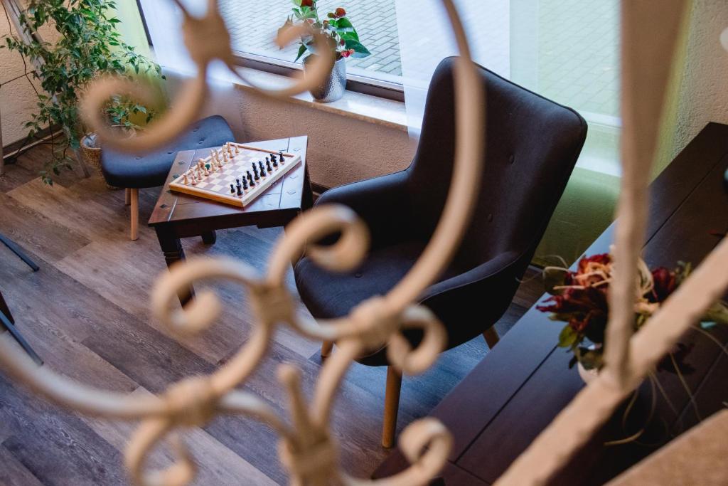 a living room with two chairs and a table at Hotel Müller in Genthin