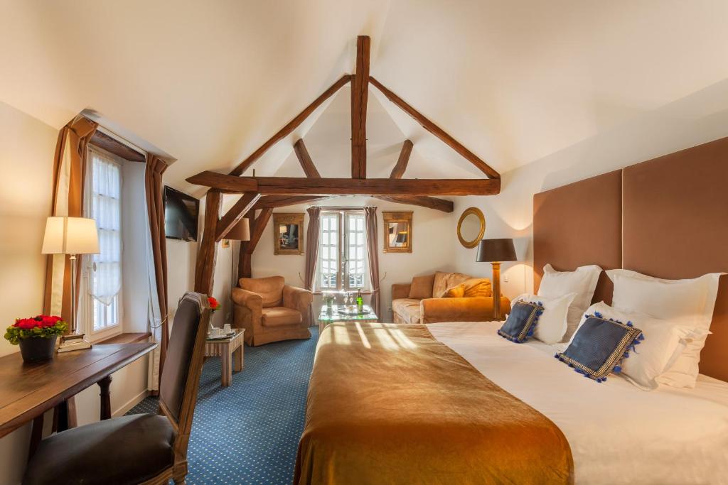 a bedroom with a large bed and a large window at Le Clos d'Amboise in Amboise