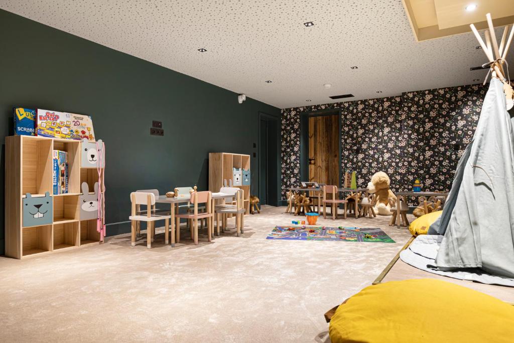 a bedroom with a room with a play area and a room with a room at Hotel Le Chabichou in Courchevel