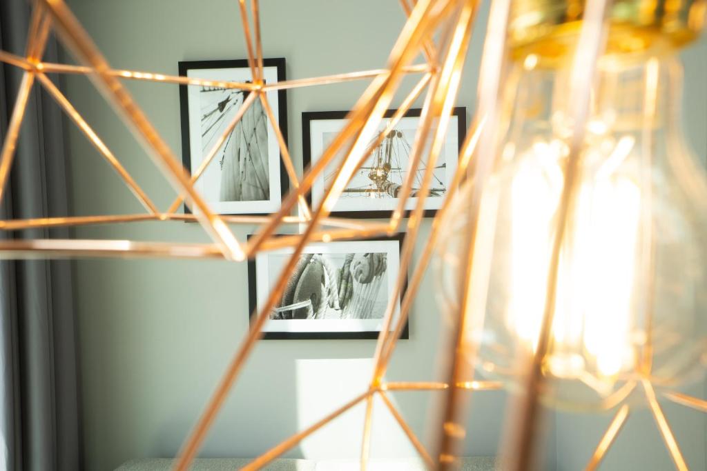 a group of framed pictures on a wall next to a shelf at HARBR. hotel Konstanz in Konstanz