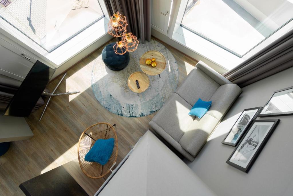 an overhead view of a living room with a couch and a table at HARBR. hotel Konstanz in Konstanz