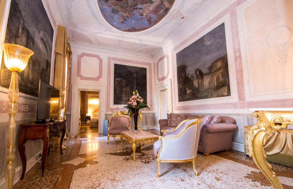 a living room filled with furniture and a ceiling at Ca' Bonfadini Historic Experience in Venice