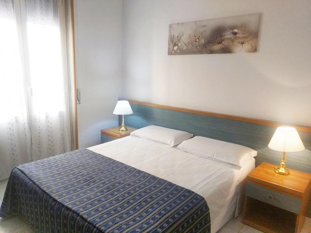 Postel nebo postele na pokoji v ubytování Albergo Athena