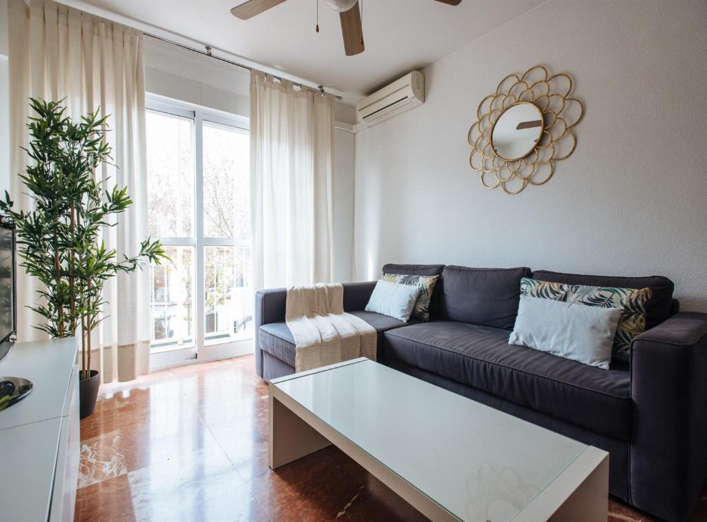 a living room with a couch and a table at Bright and Familiar Apartment in Alameda in Seville