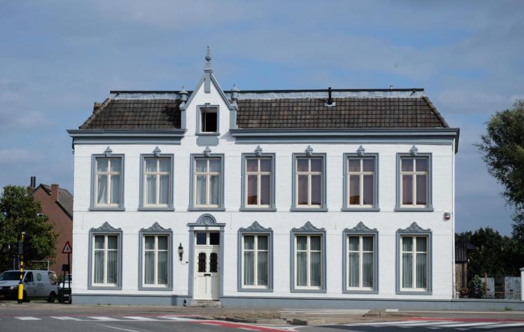 a large white building with a gambrel roof at B&B Het Doctershoes in Kinrooi
