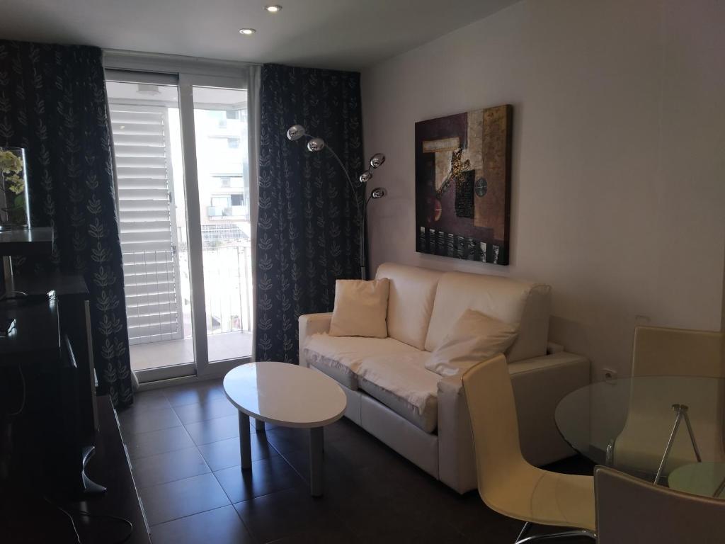 a living room with a couch and a table at Apartamentos Rosi in Benicarló