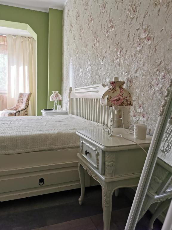 a bedroom with a bed and a table and a chair at Chic Apartment in Brăila