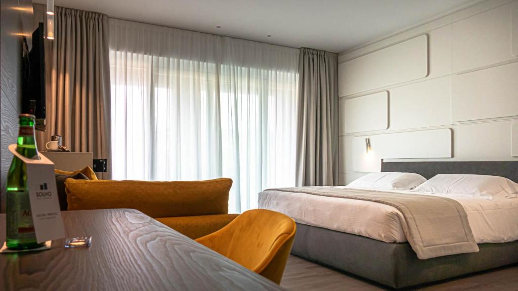 Postel nebo postele na pokoji v ubytování Solho Hotel