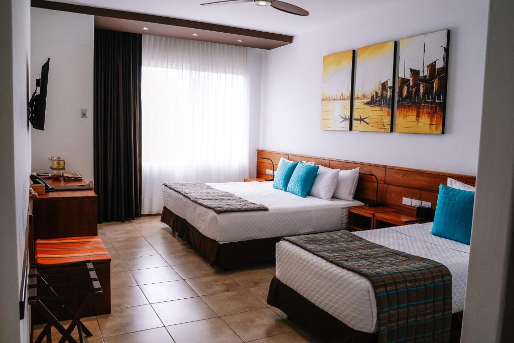 Postel nebo postele na pokoji v ubytování Hotel Cucuve