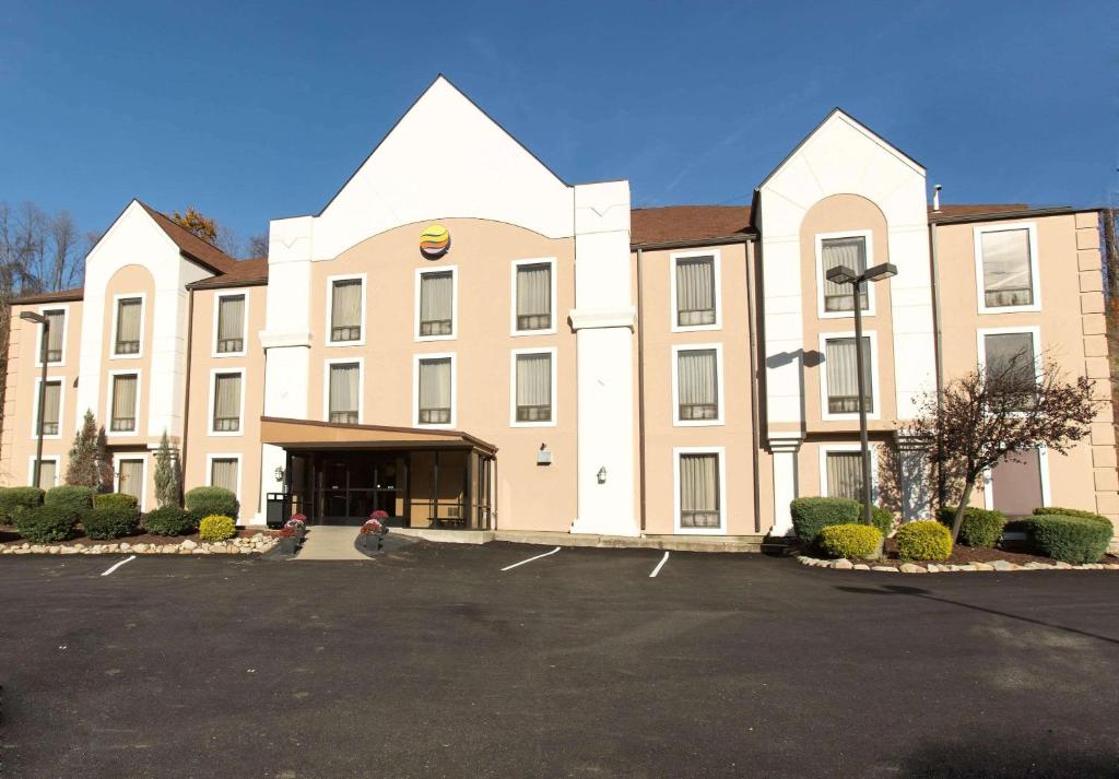 a large building with a parking lot in front of it at Comfort Inn Pittsburgh Crafton in Pittsburgh