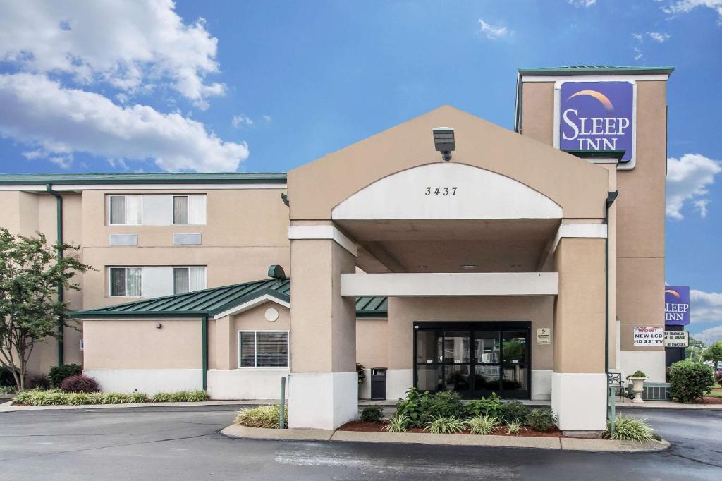 
a large building with a sign on the front of it at Sleep Inn in Nashville
