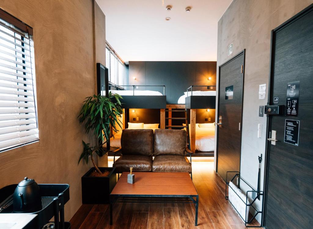a living room with a couch and a bedroom at mizuka Nakasu 1 - unmanned hotel - in Fukuoka