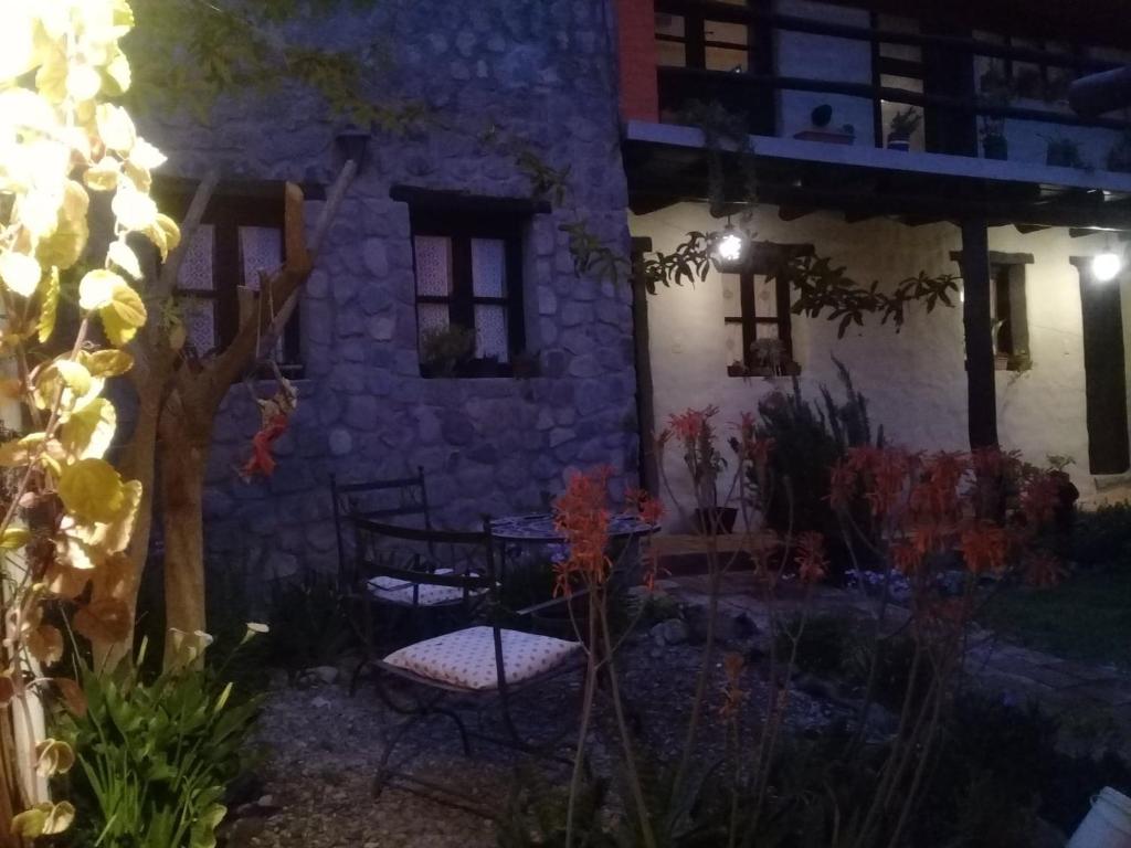 a patio with a table and chairs in front of a building at Karallantay in Tilcara