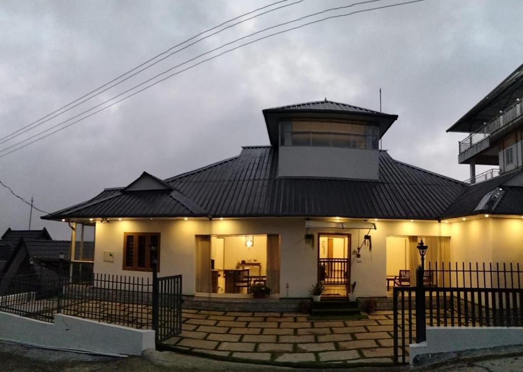 a small white house with a black roof at Vagamon Hill Chimes in Vagamon