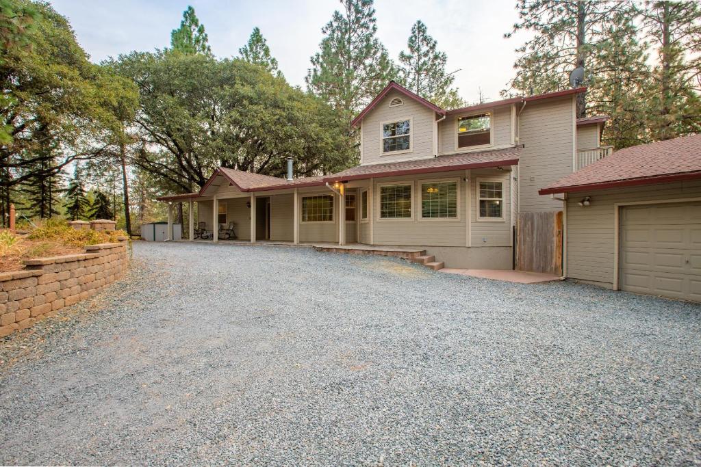 a house with a driveway and a garage at Mountain Retreat with Hot Tub & Pool Table - 1 hour from Squaw Valley Resort! in Colfax