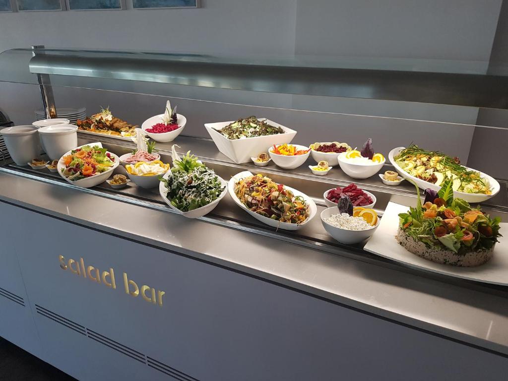 a buffet line with many different dishes of food at Faros Hotel Ayia Napa in Ayia Napa